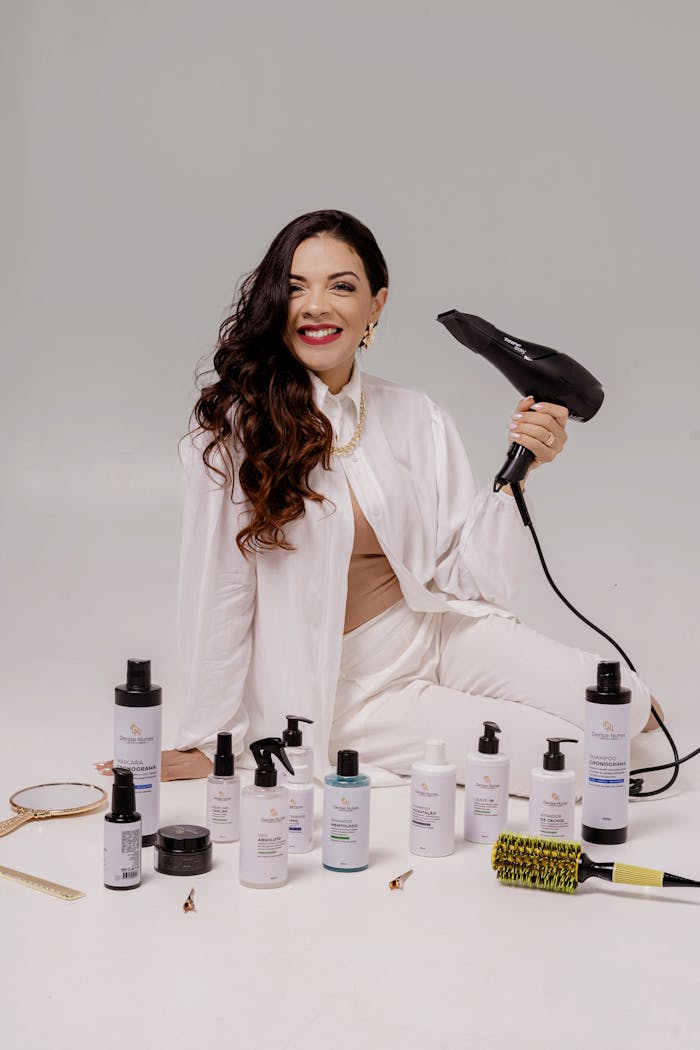 services-04 A stylist with hair care products and a blow dryer, showcasing a modern beauty setup.
