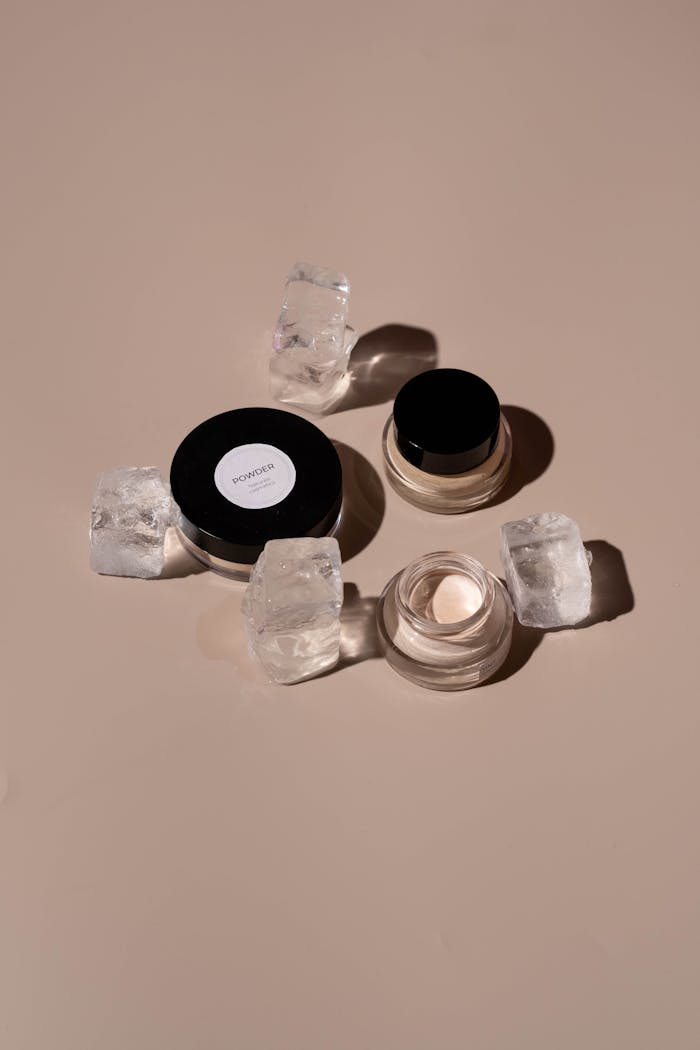 gallery-2 Still life of makeup products with ice cubes on a neutral background, offering an elegant minimalist aesthetic.